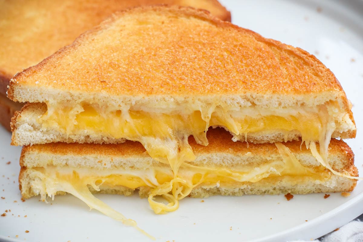 Air Fryer Toasted Cheese sandwiches sliced in two