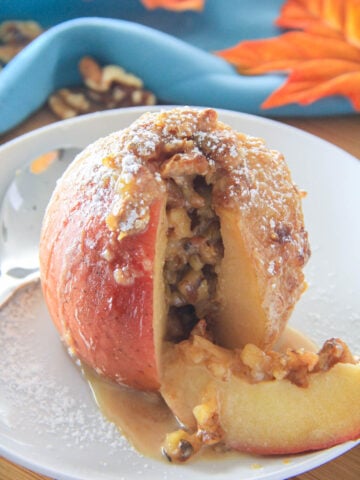 Baked Apple with a missing slice on a white plate
