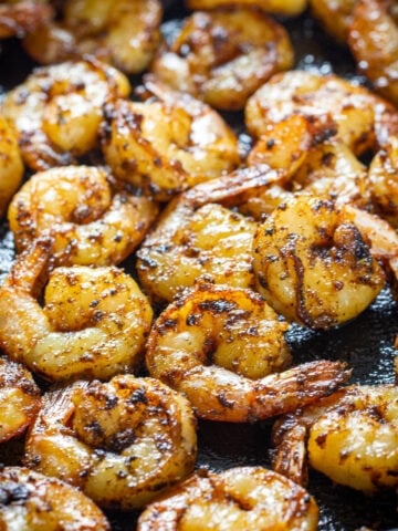 Vertical image of Cajun Shrimp in a skillet