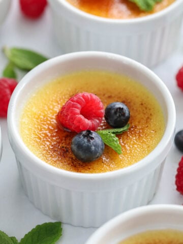 creme brluee topped with berries and mint.
