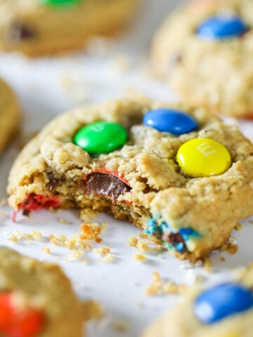 Close up of Colossal Cookies, one missing a bite.