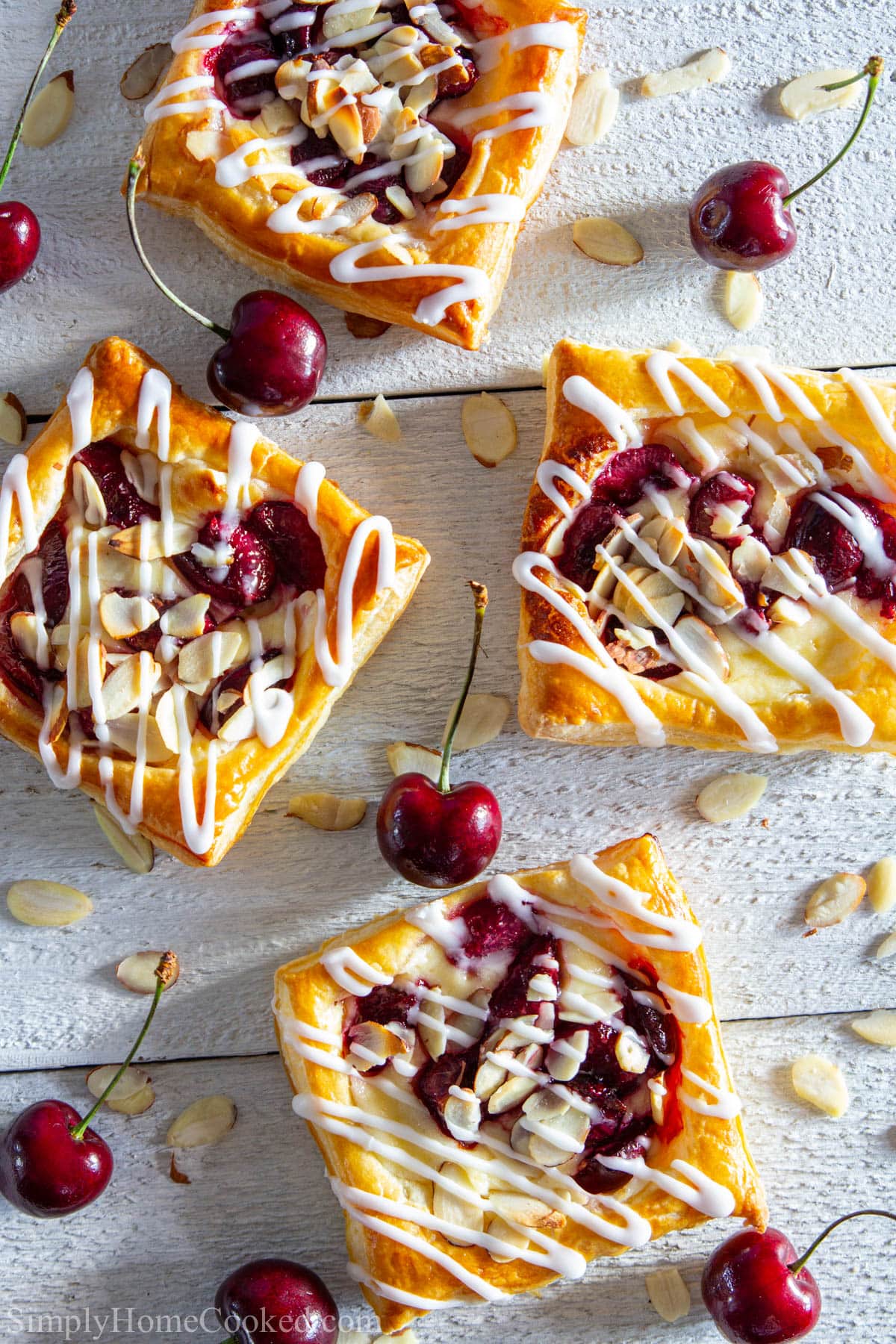 Cherry Danishes among cherries and almond slices.